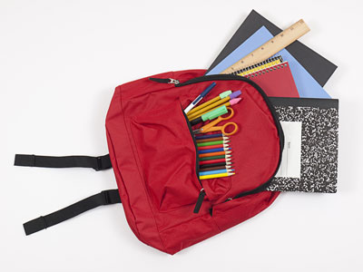 Backpack with various school supplies.